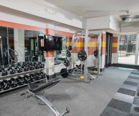 Fitness center at The Den student apartments